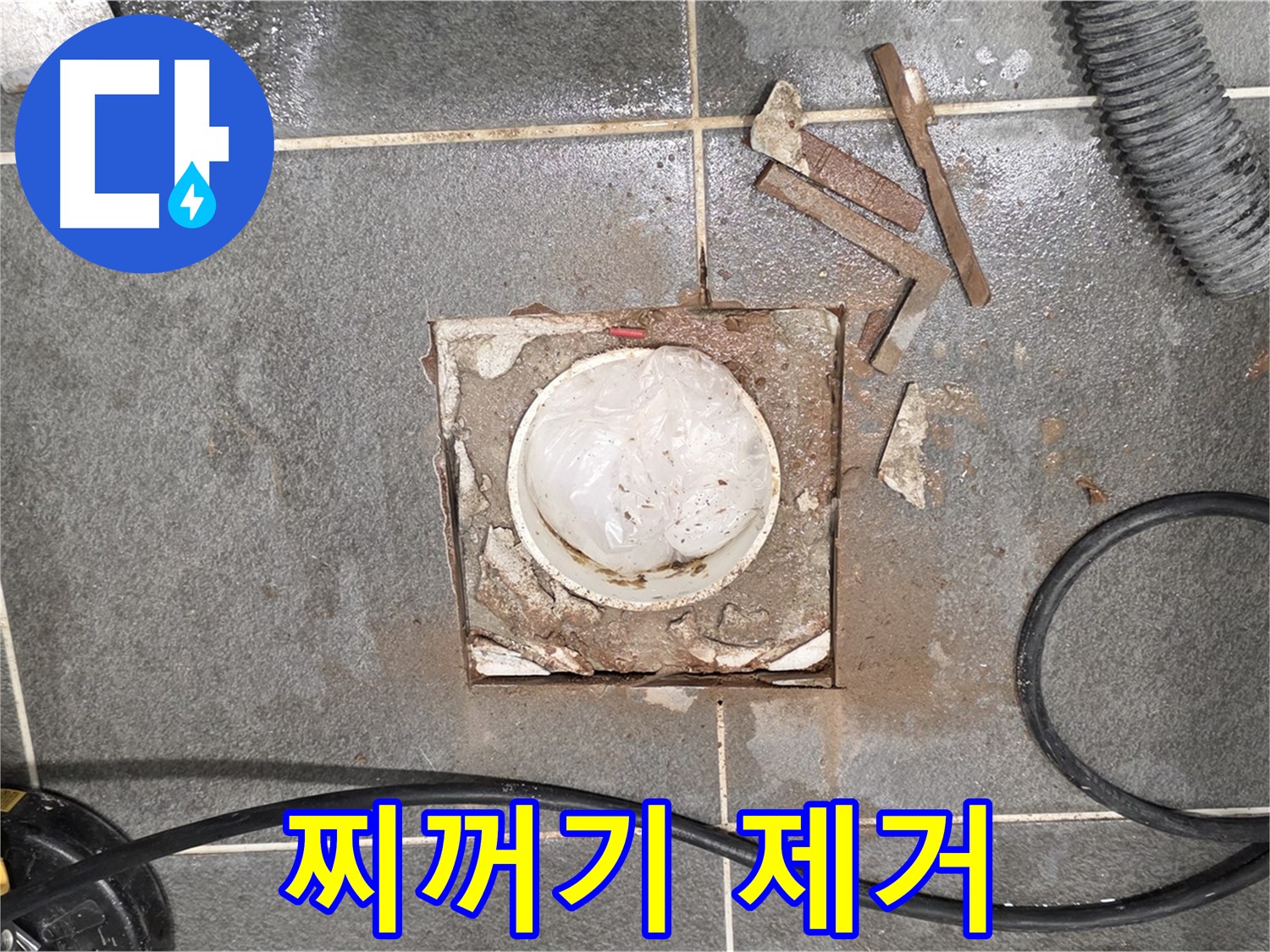 운정 욕실 배수구 누수 - 타일 제거 후 배관 주변 찌꺼기를 제거하는 모습