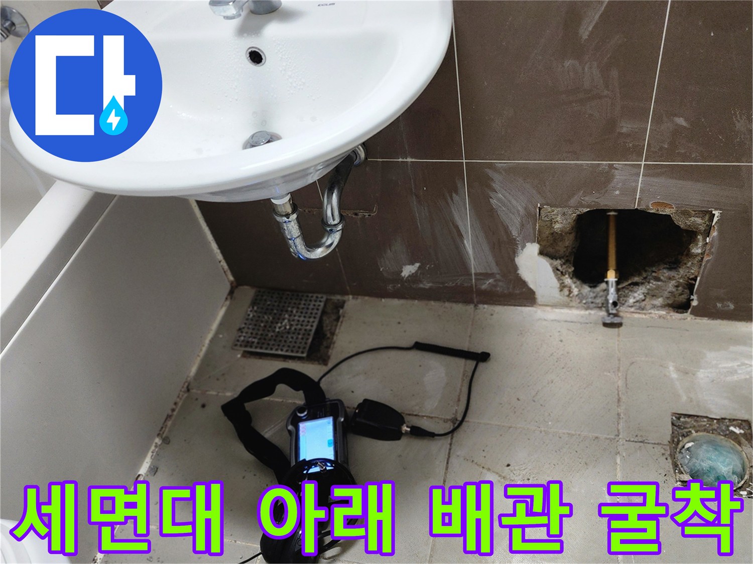 세면대 하단-벽면 타일을 제거하고 노출된 배관 상태를 점검하는 모습
