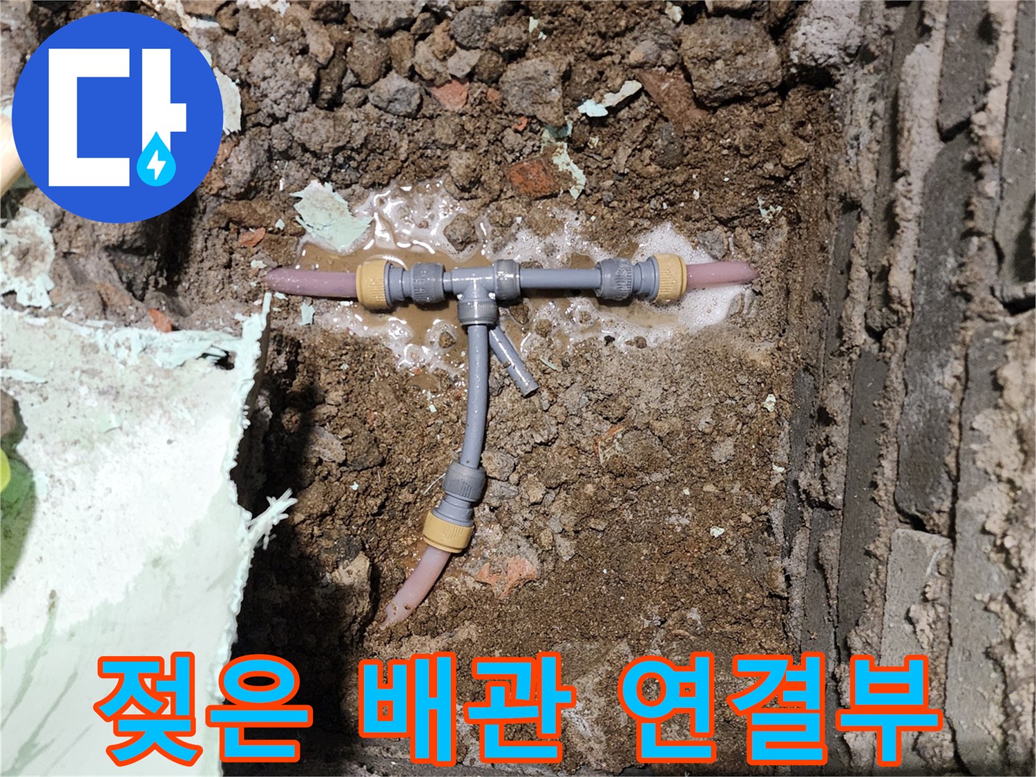 누수로 인해 주변 흙이 젖어 있는 배관 모습