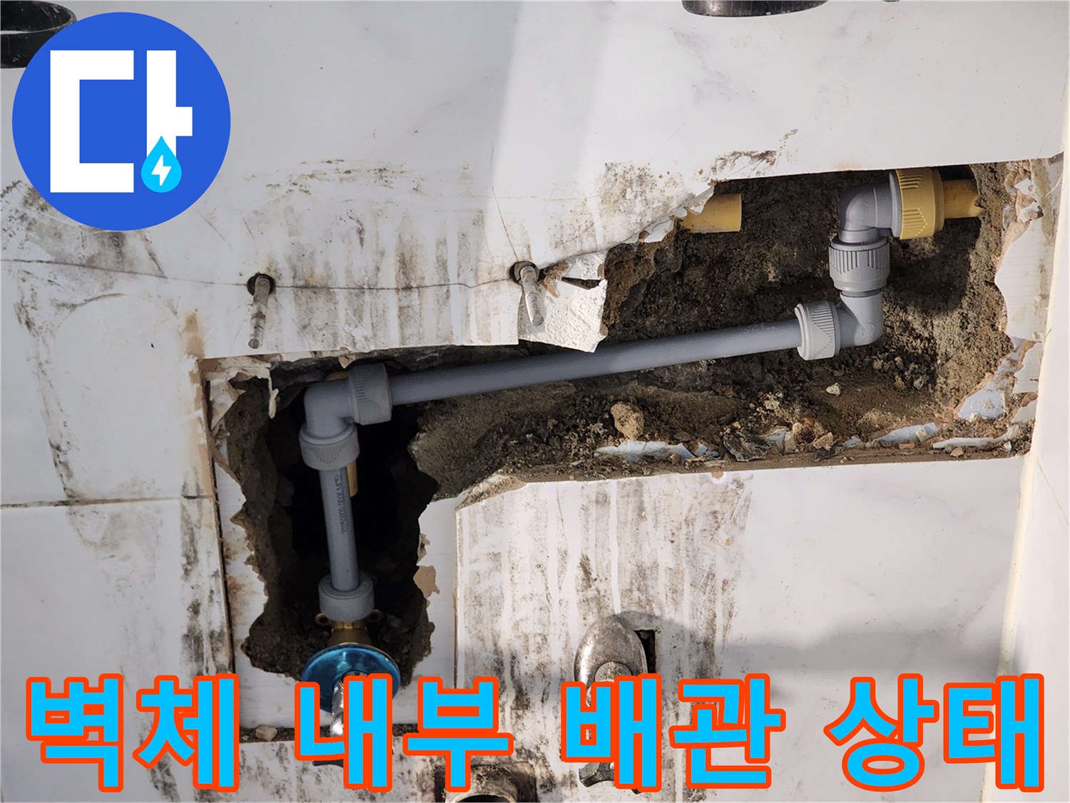 타일을 제거하여 드러난 벽면 배관 및 밸브 연결 부위