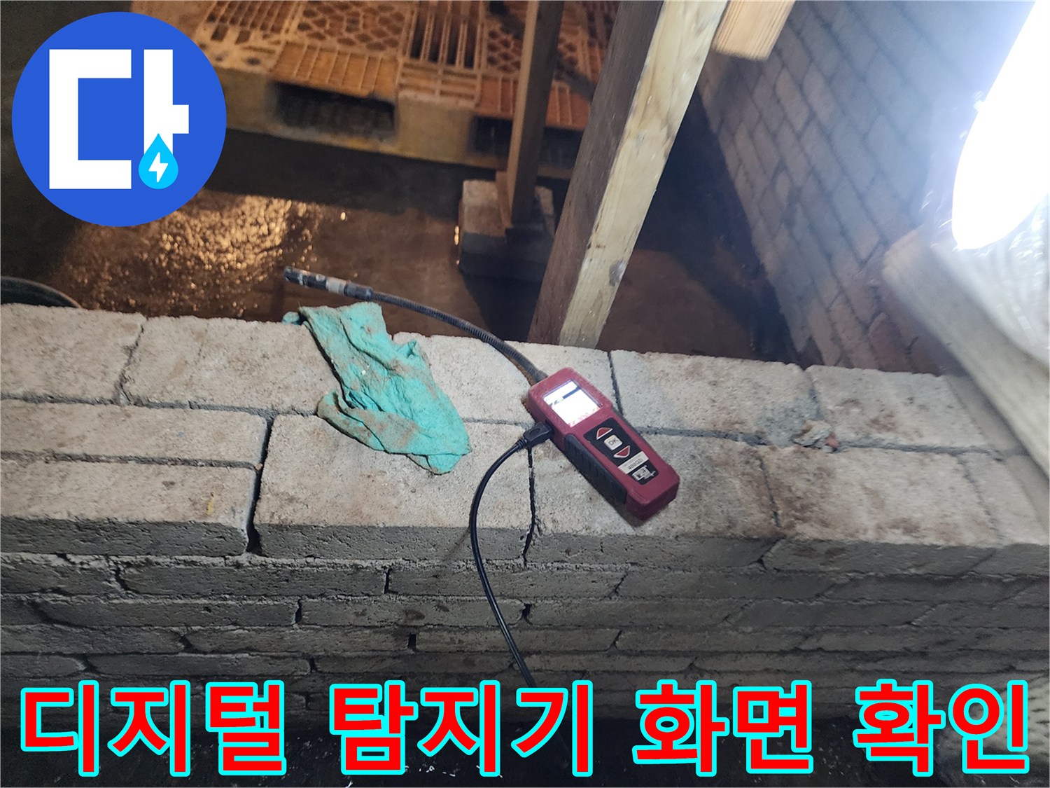 벽돌 벽면 아래 설치된 가스식 누수 탐지 장치 사진
