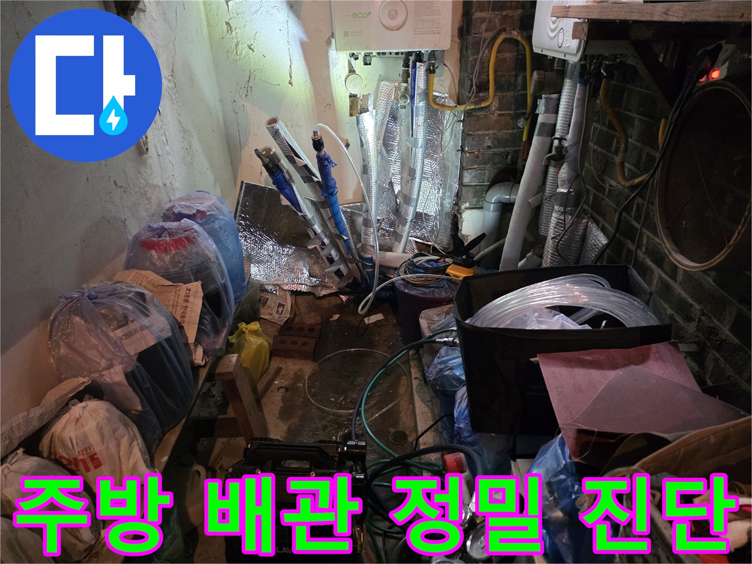 복잡하게 얽힌 주방 배관과 점검용 장비가 놓인 현장 모습