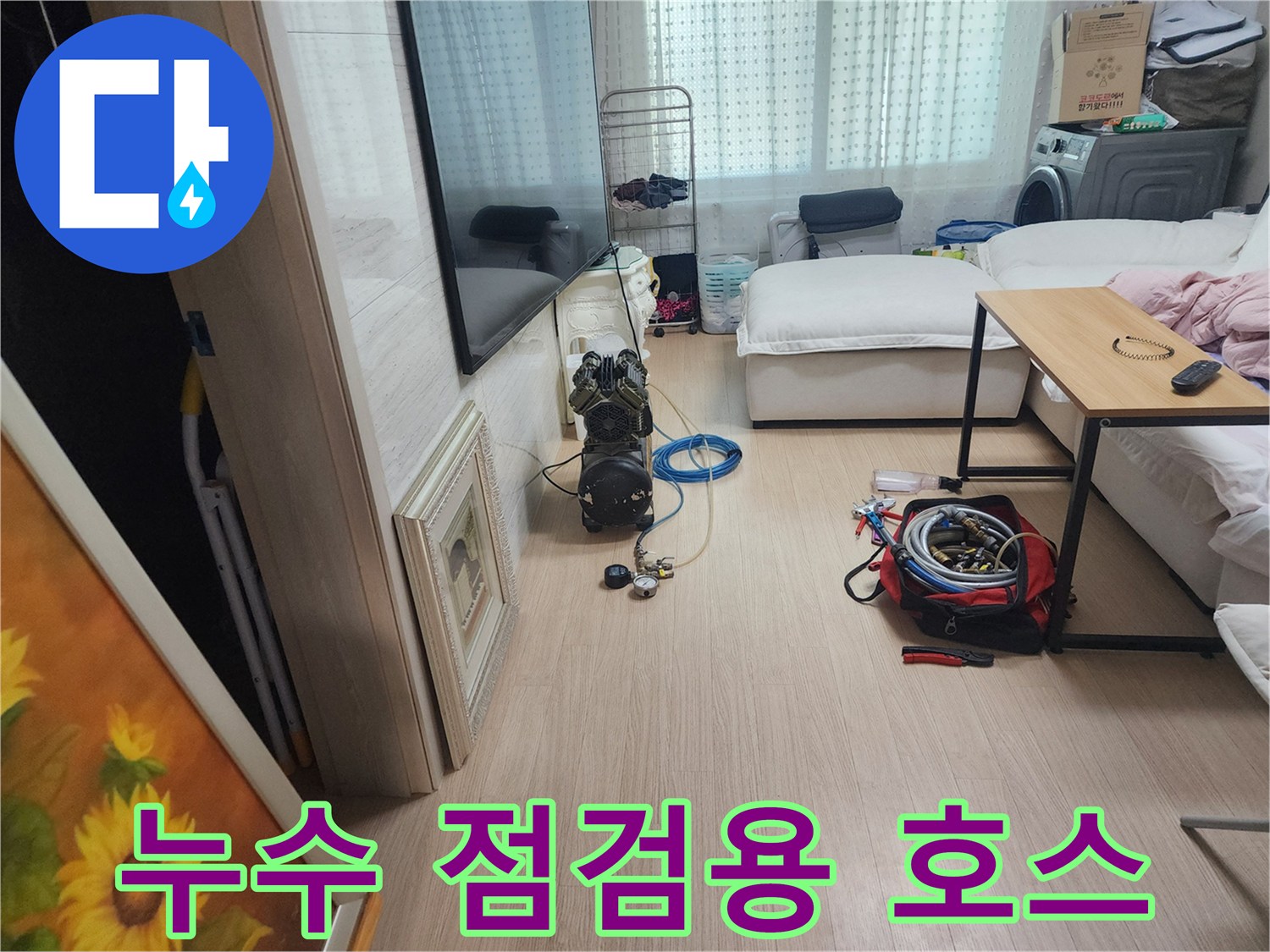 배관 압력 테스트를 위해 바닥에 놓인 파란색 호스와 장비