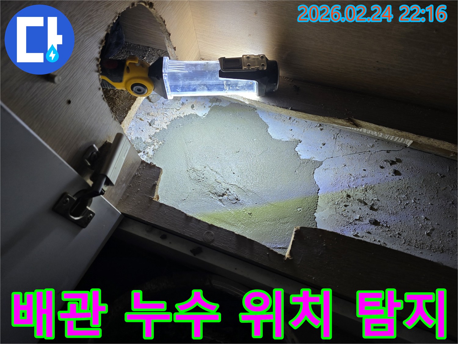 누수-엔지니어가-어두운-싱크대-하부에서-배관-누수-위치를-정확히-찾기-위해-조명-장비를-활용하는-현장