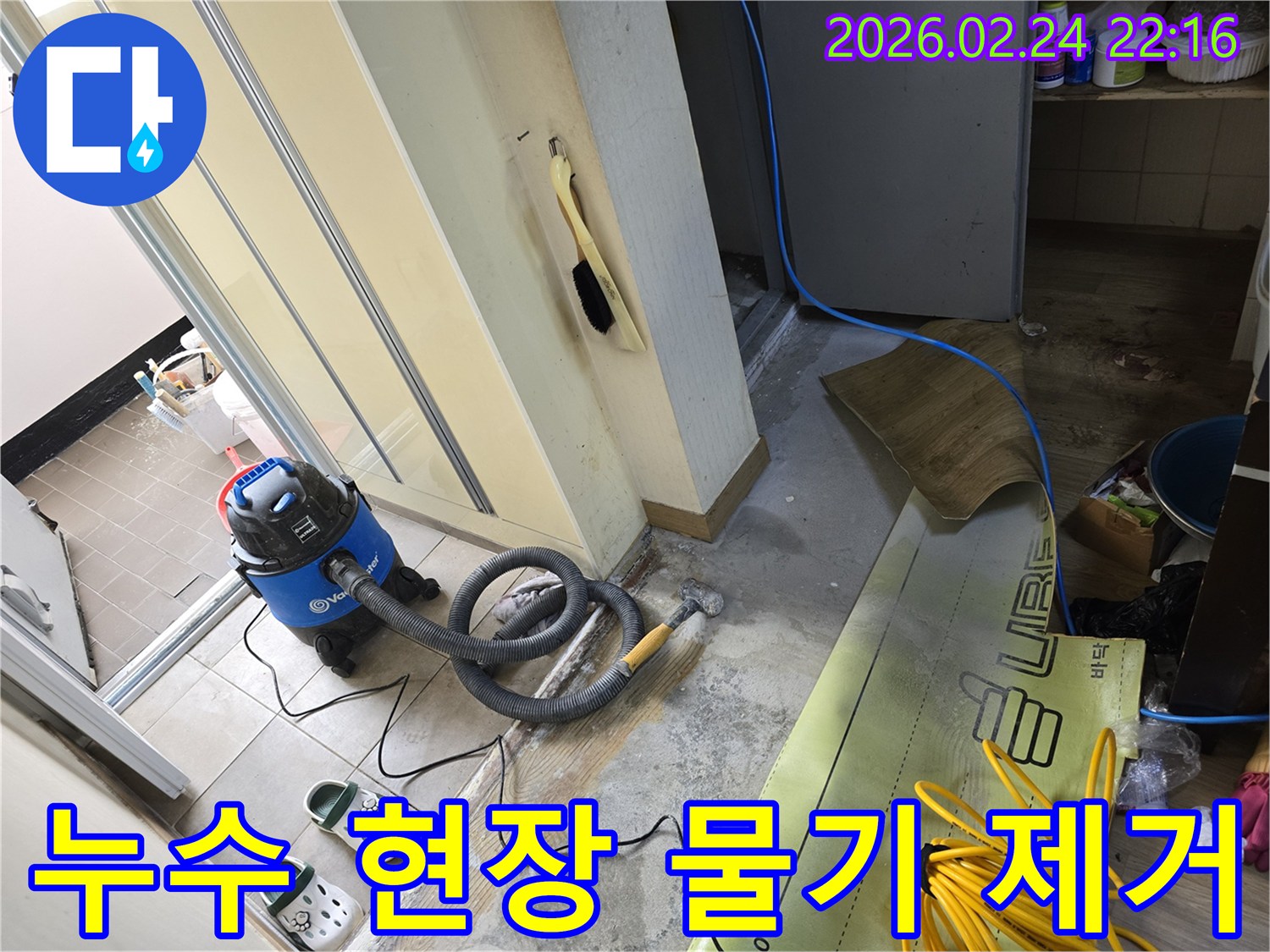 누수 지점에서 물기를 효과적으로 제거하기 위해-강력한 습식 청소기를 사용하는-공사 현장입니다.