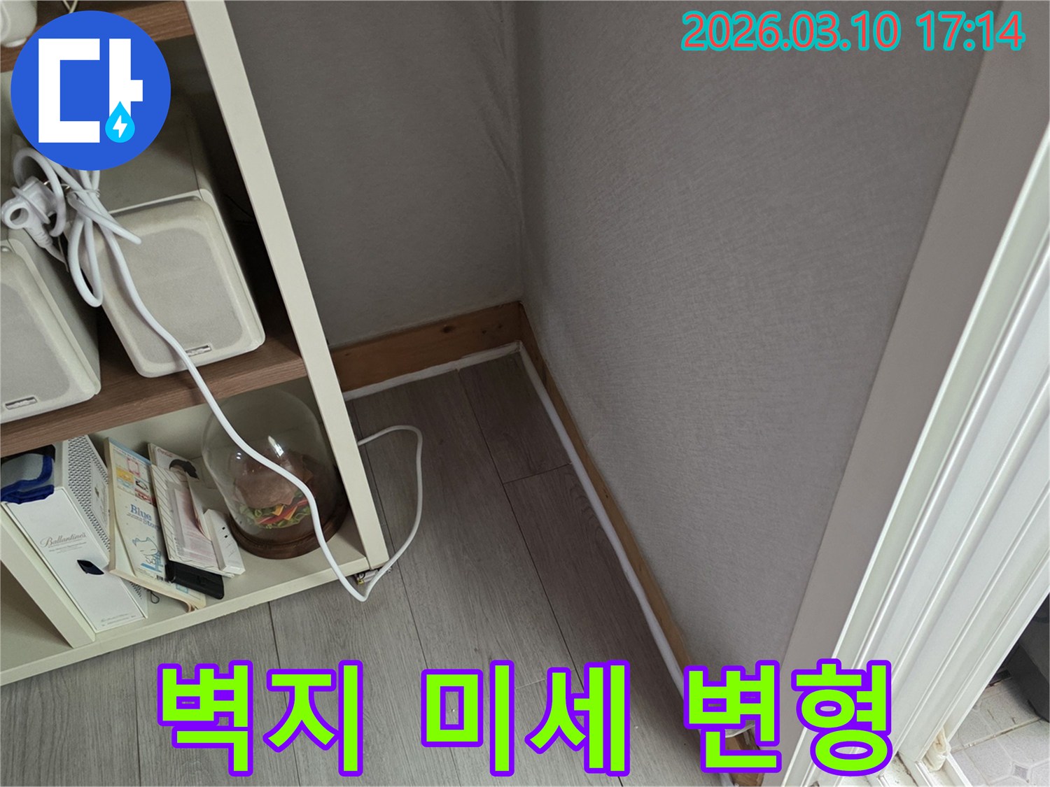 벽면 하단부의-벽지가-미세하게-변형되거나-울퉁불퉁해진-모습은-누수로 인한-수분 침투의-초기 증상입니다