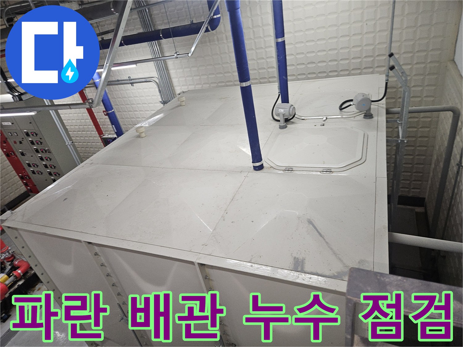 설비실 탱크 상단의 파란색 배관과 전기 제어부 부품