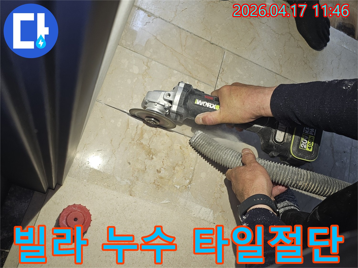 빌라 누수 해결을 위해 작업자가 그라인더로 바닥 타일을 절단하고-있으며-동시에-흡진기로-먼지를-제거하여-깨끗한-작업-환경을-유지하는-모습입니다.