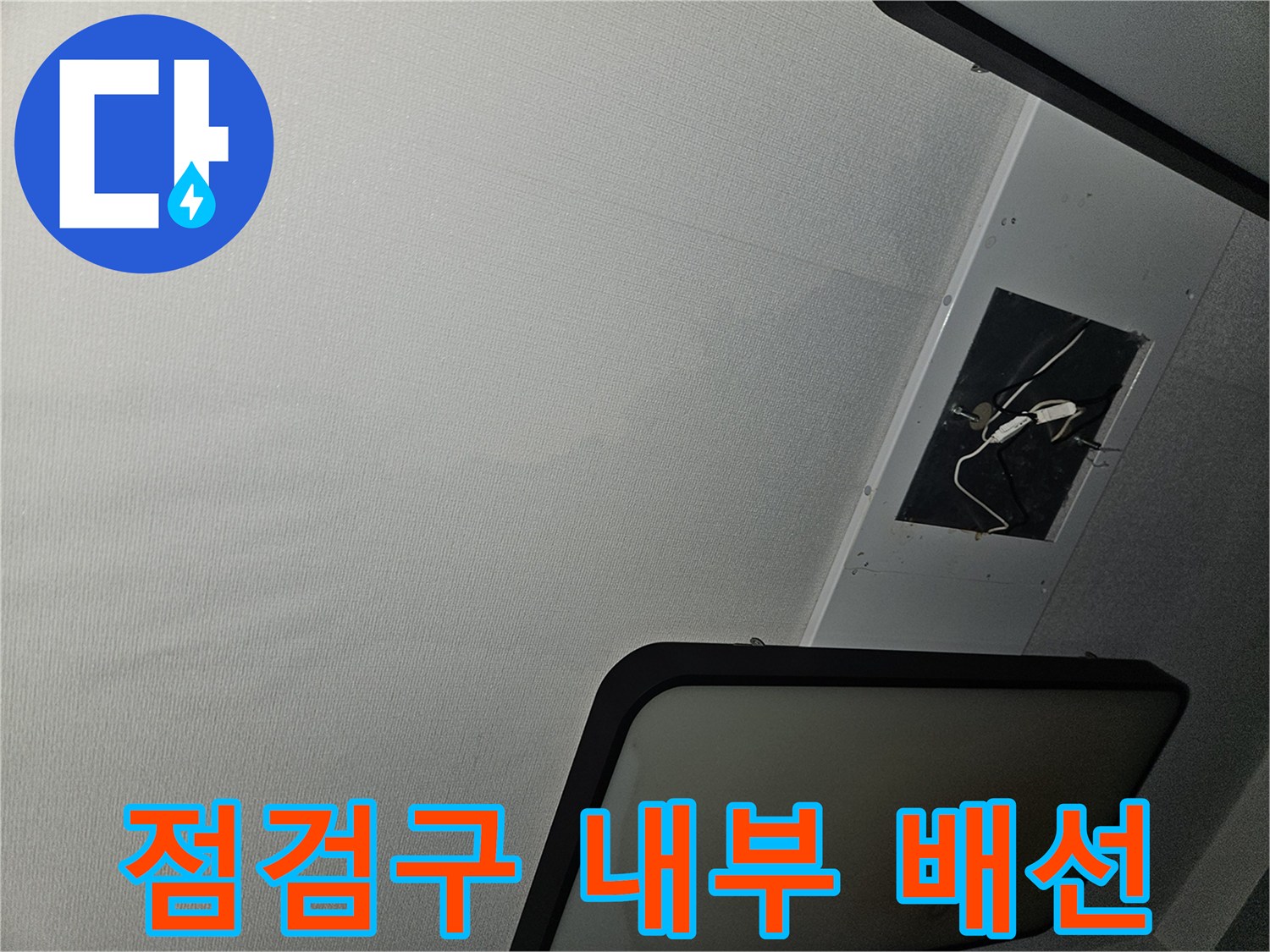 천장 점검구 사이로 보이는 전선과 천장 구조물