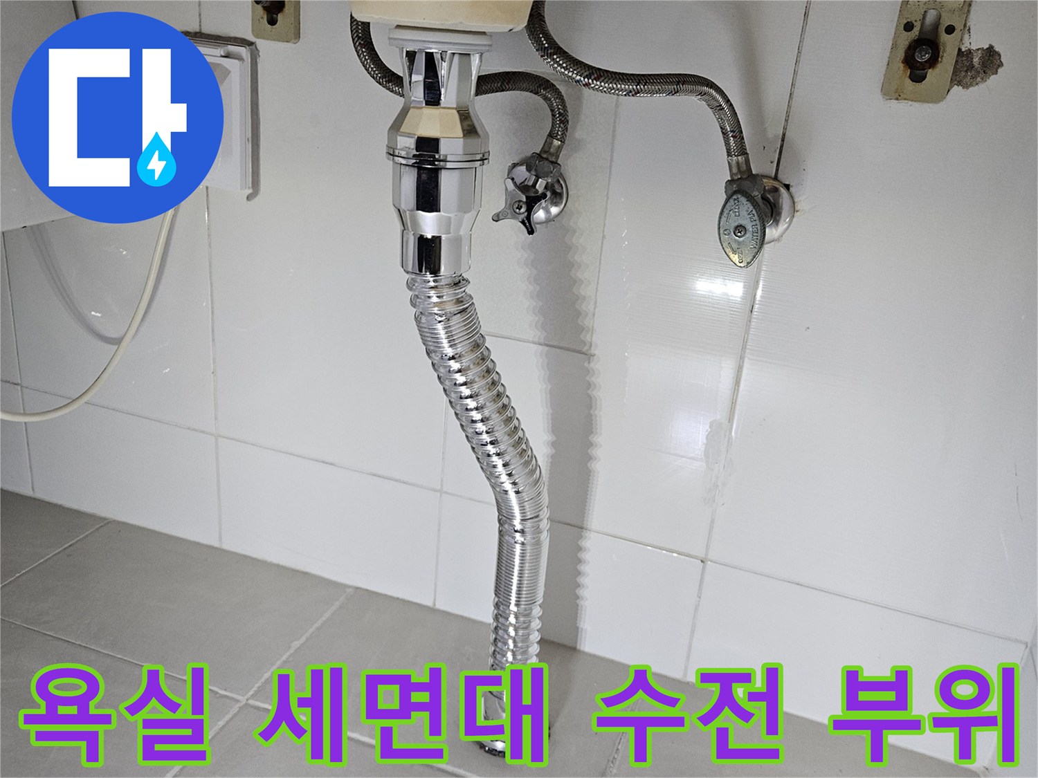 세면대 하단에 설치된-금속 재질의 수전과 배수관 연결 상태