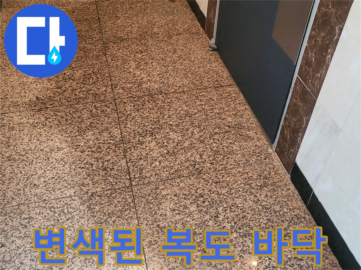 습기가 침투하여 어둡게 변한 복도 석재 타일의 모습