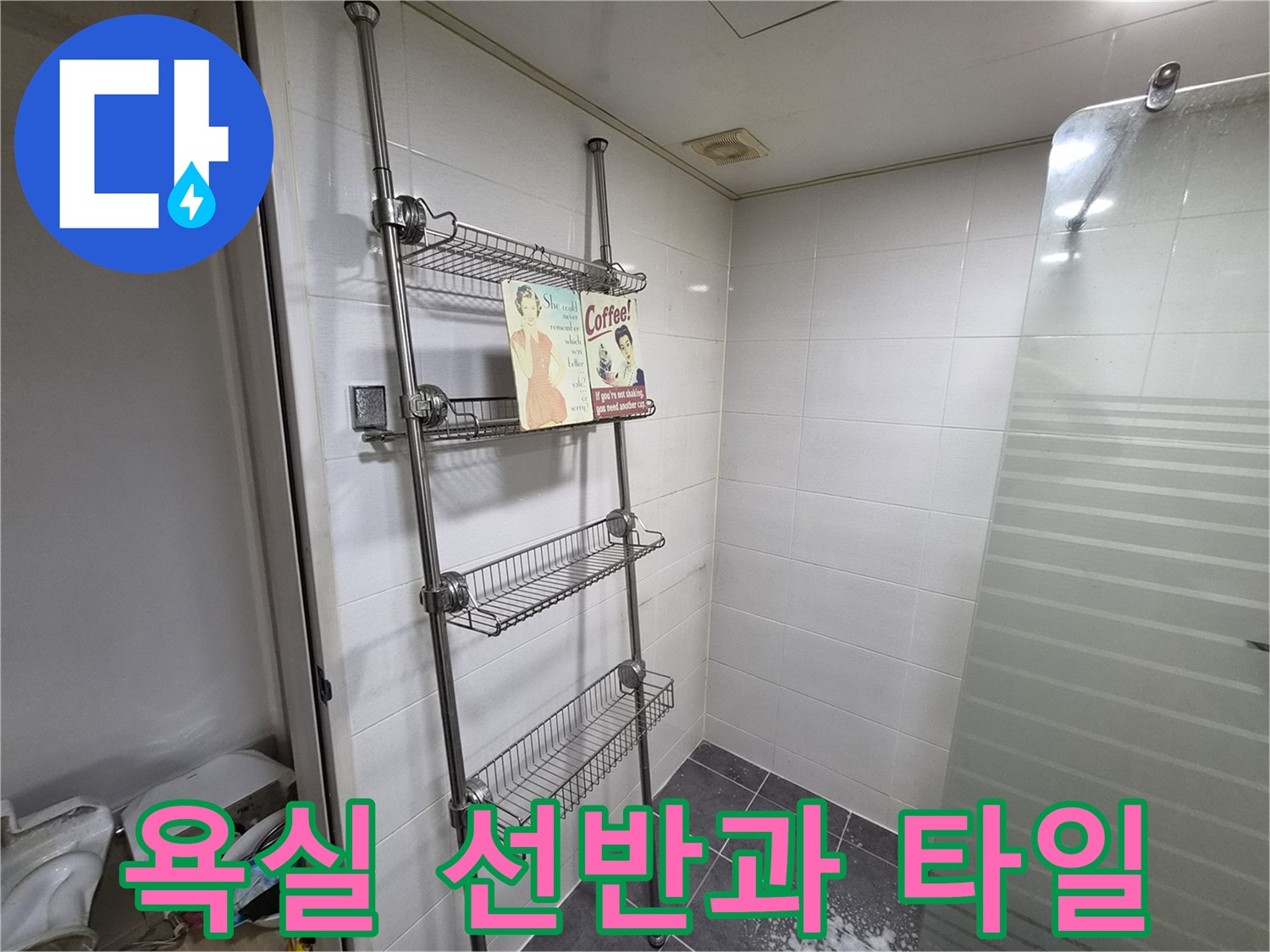 화장실 벽면에 설치된 스테인리스 선반과 흰색 타일 모습