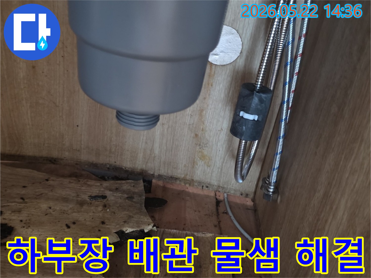 싱크대 하부장 내부의 배관 주변에서 발생한-물샘 현상과-손상된 목재를 보여주는 누수 현장 사진