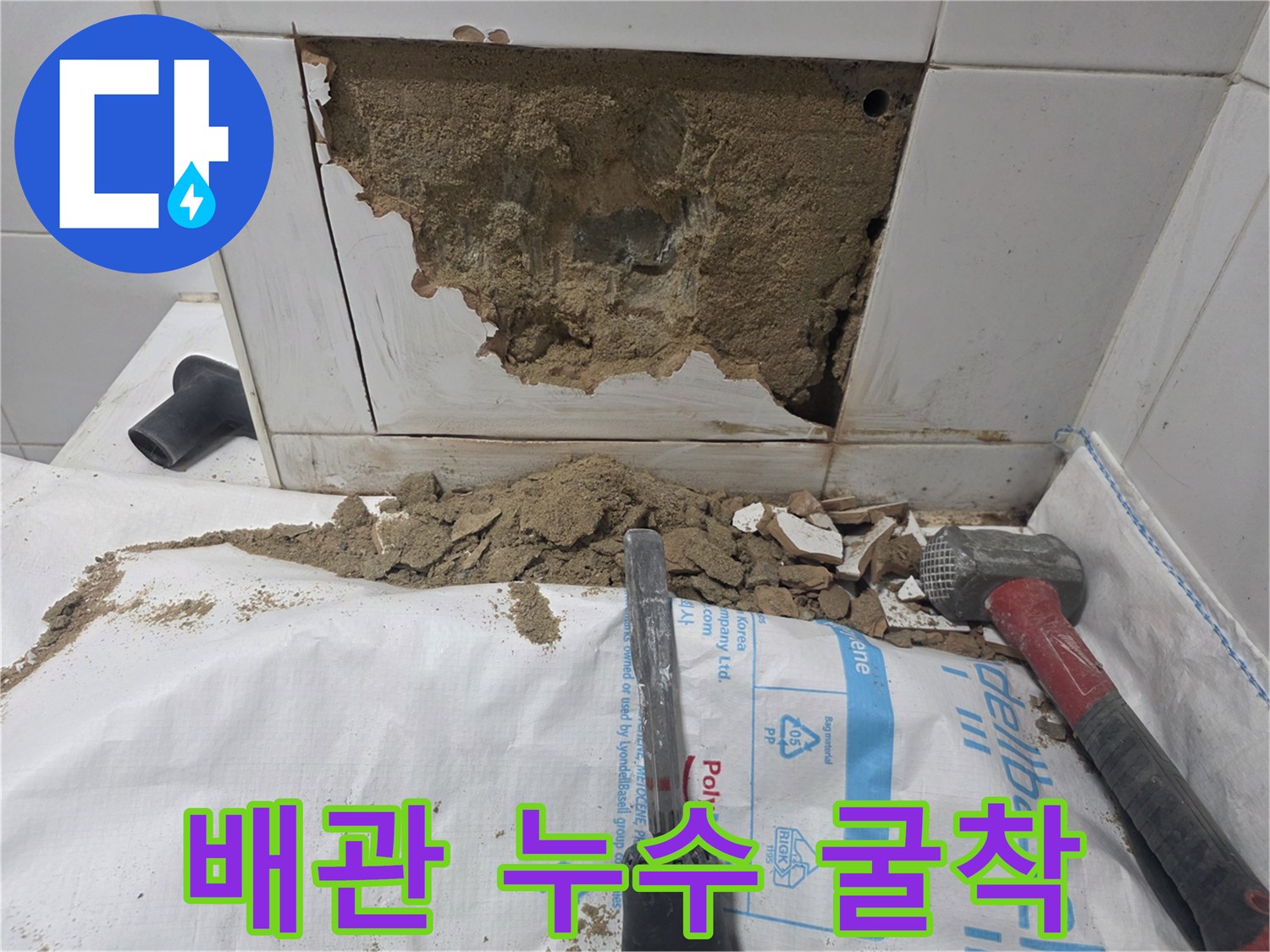 욕실 타일 내부의 배관 누수 지점을 찾기 위해 파쇄된 벽면 상태