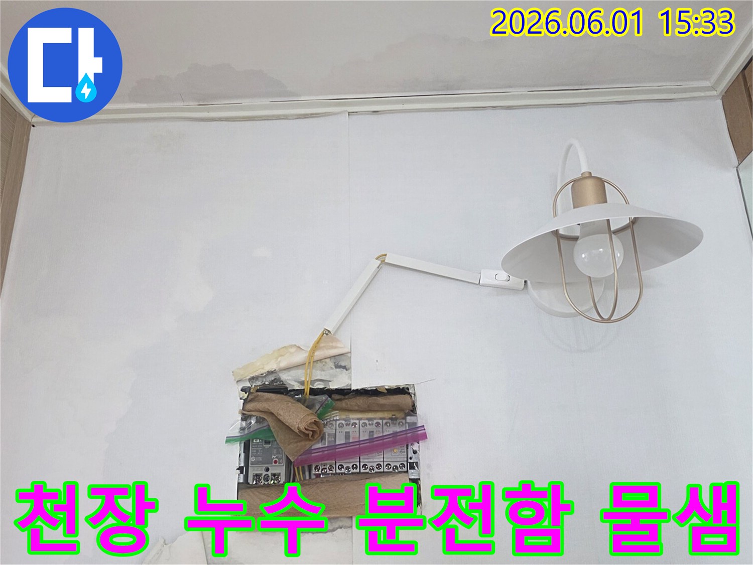 천장에서 물이 새어 분전함 주변으로 흘러내리는 심각한 누수 상황을 보여주는 이미지입니다-전기 안전에 유의해야 합니다