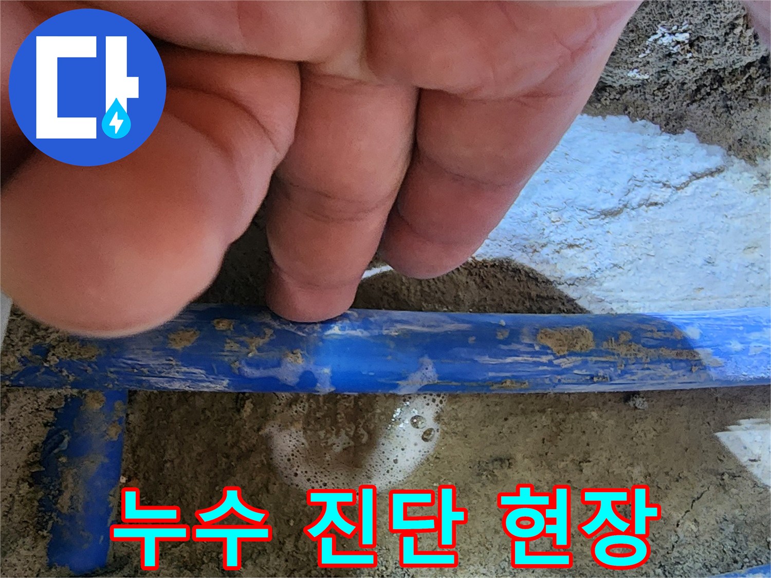 엔지니어의 손가락이-파란색 수도관의-누수 지점을 가리키며-신속한 진단 과정을-보여주는 사진
