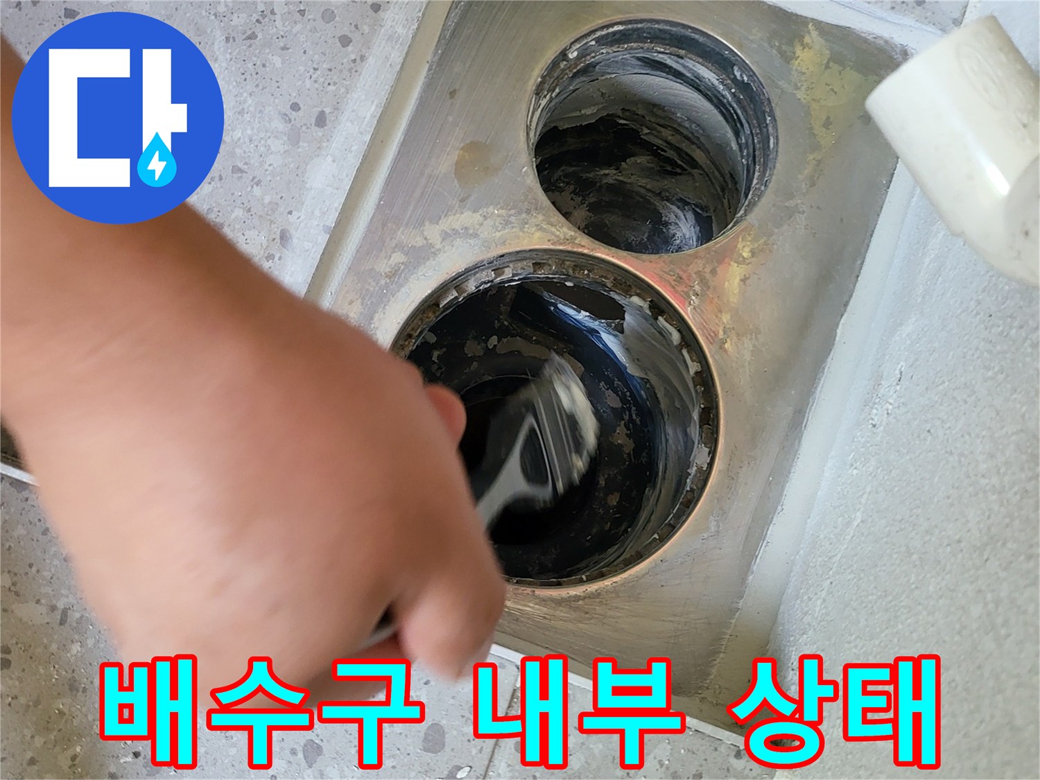 배수구 입구 주변의 오염된 배관 내부를 살펴보는 사진입니다