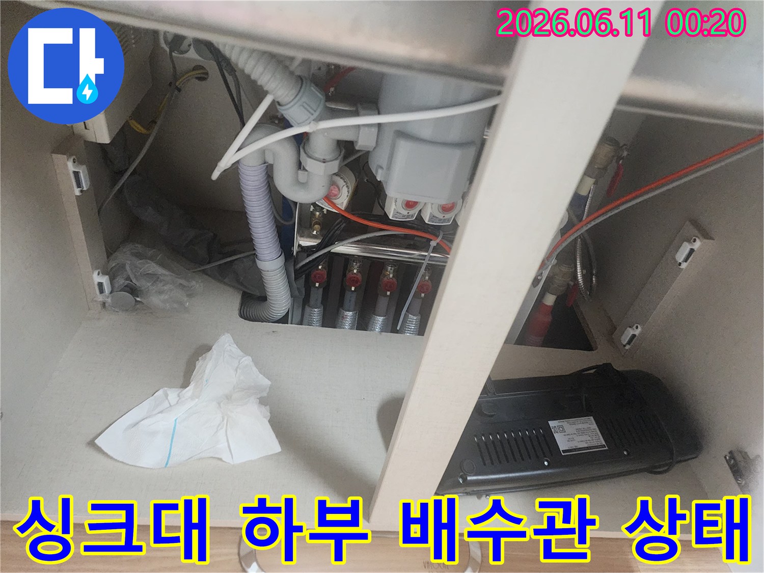 식사동 싱크대 하부장 내부의 복잡한 배수관과 연결 부위 모습입니다.