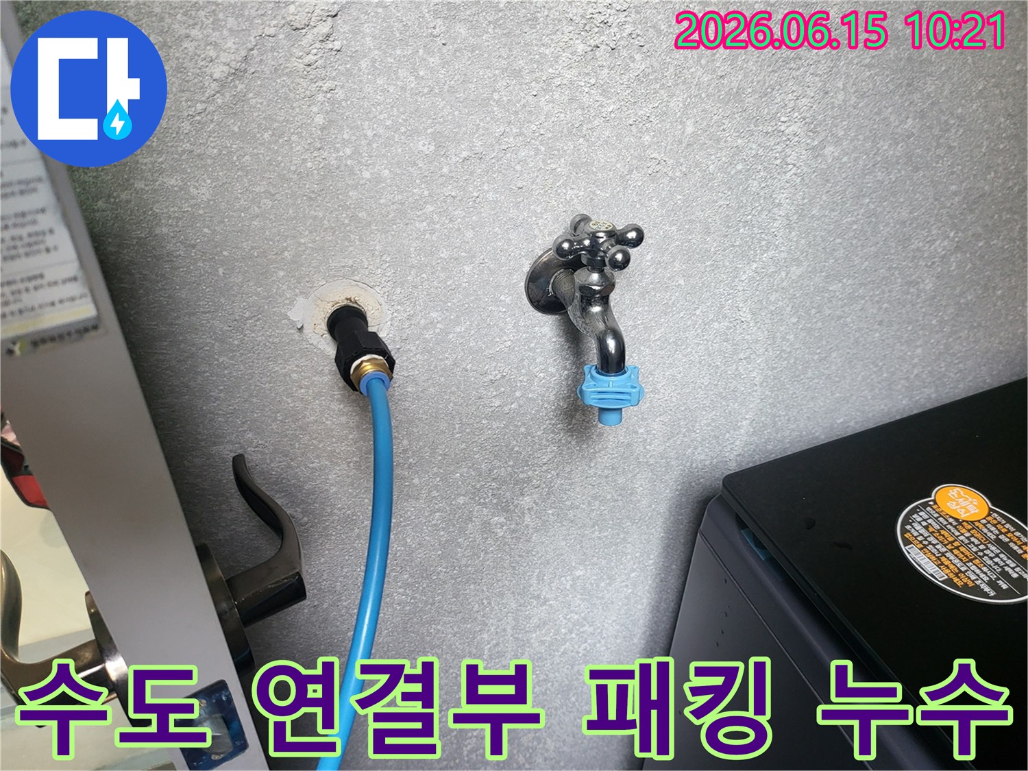 회색 벽에 연결된 수도 호스-연결 부위의 낡은 패킹으로 인한 누수를 점검하는 모습