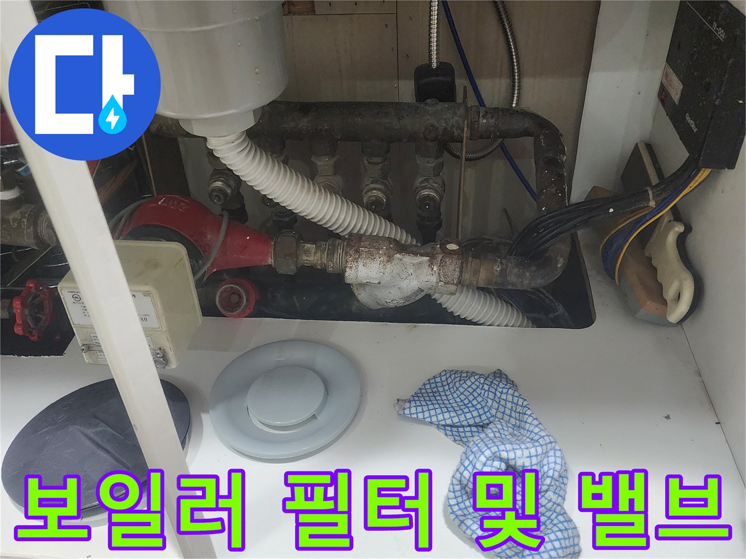 보일러실 내부의 하얀색 주름관과 금속 배관 연결 부위