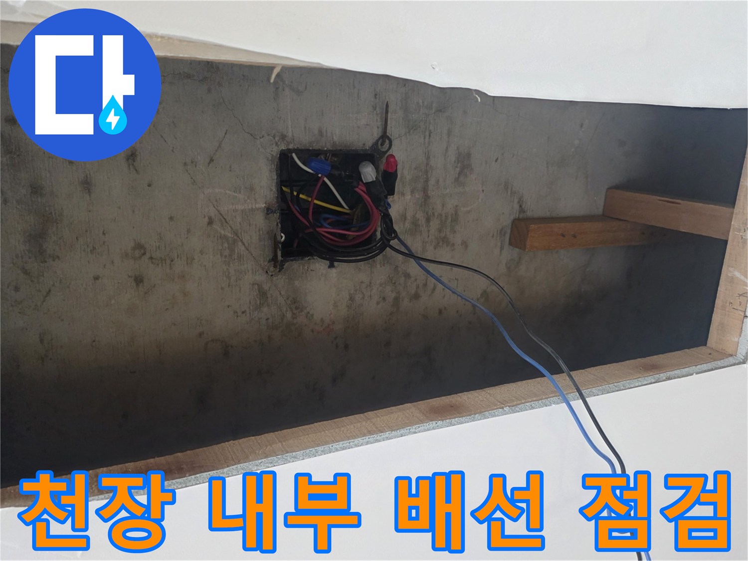 천장 틈새로 드러난 전기 연결 부위와 목재 구조물 프레임
