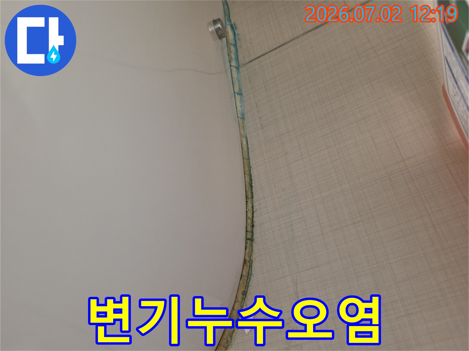 변기 하단과 바닥 타일 경계면에서-누수로 인해 발생한-변색과 오염을-자세히 보여주는 사진입니다.
