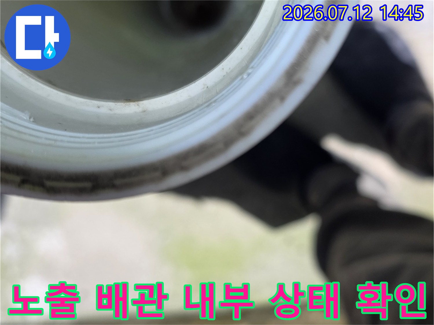 싱크대 아래 배관을 가까이서 촬영하며 세밀하게 검사하는 모습