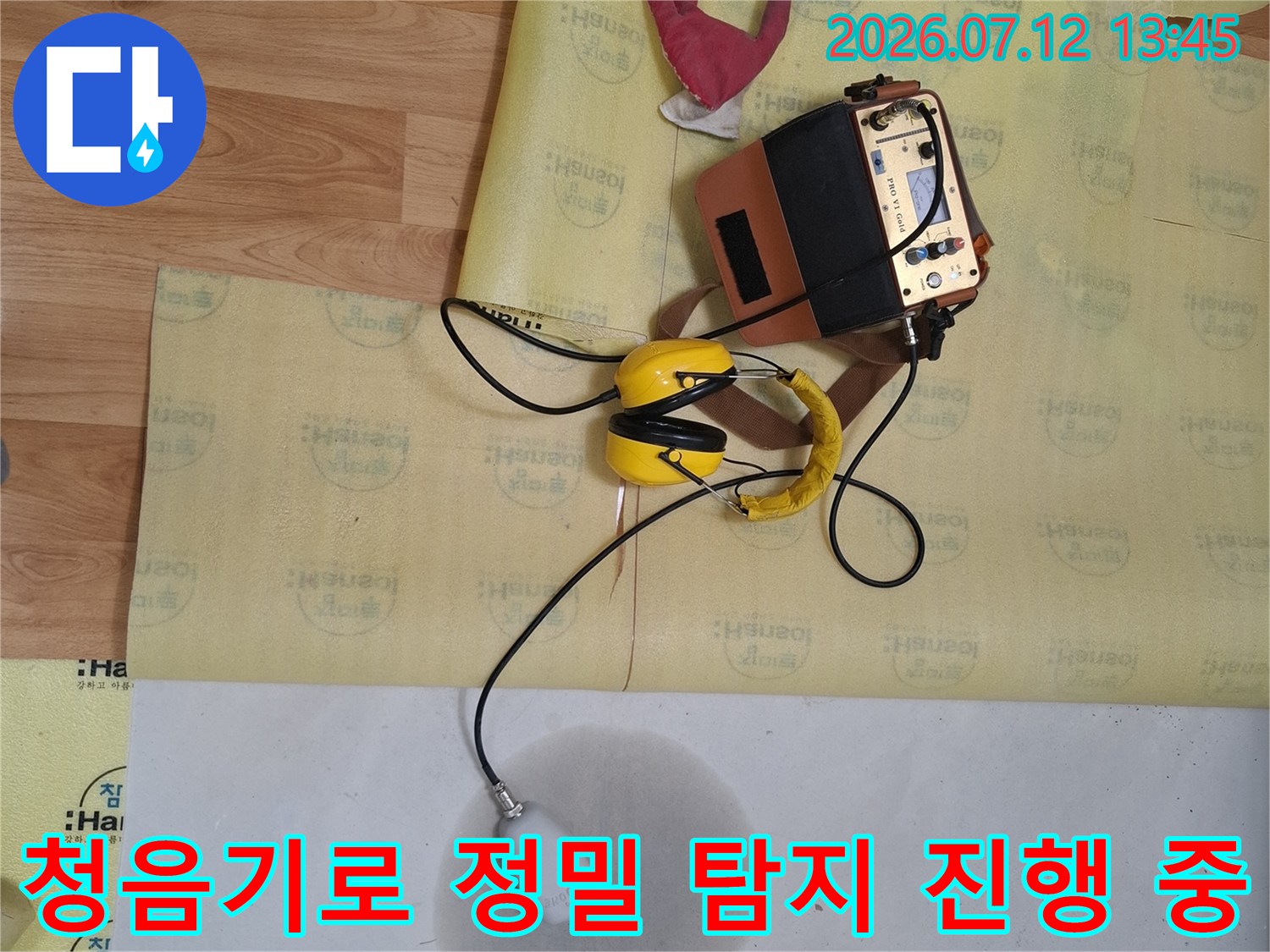 전문가용 청음 장비를 사용하여 배관의 누수 지점을 정확하게 찾아내는 장면