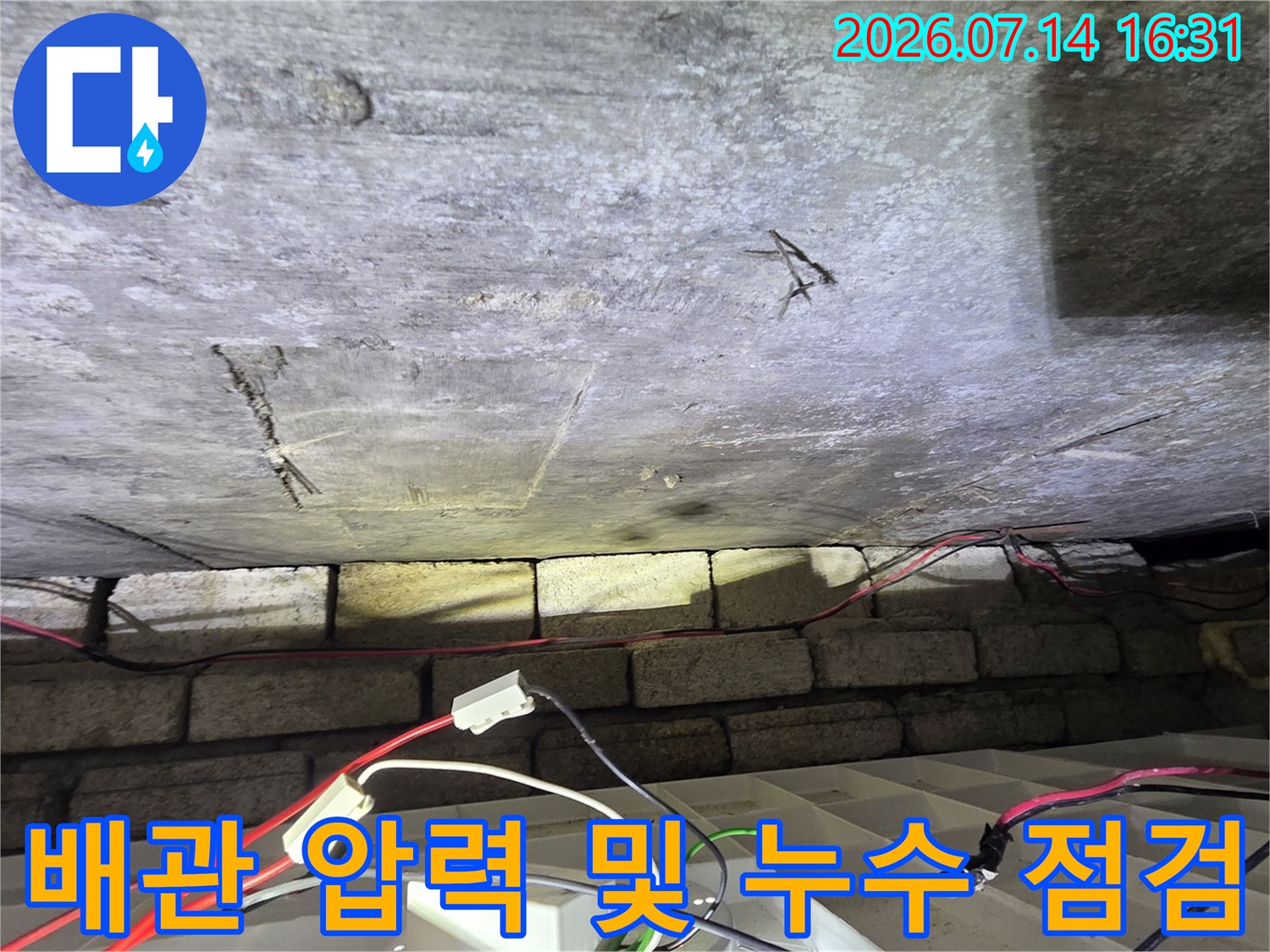 천장 안쪽 배관에 연결된 계측 장치와 진단용 작업 환경