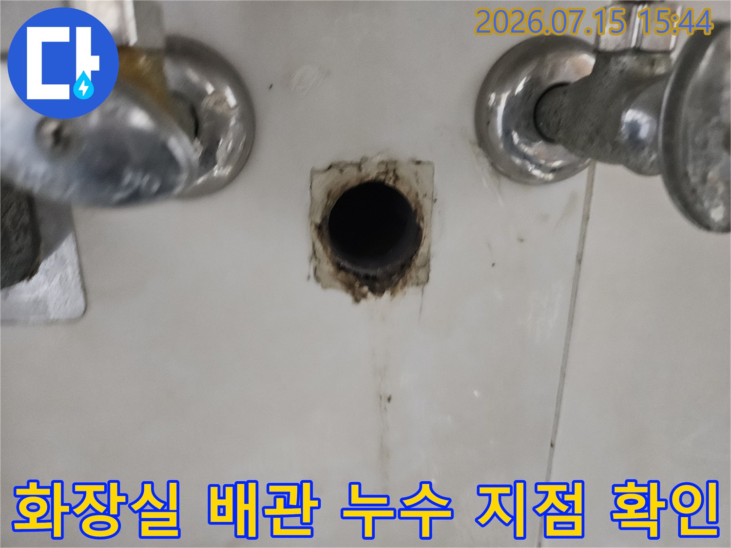 세면대 하단 노출된 배관 부위의 누수 흔적과 파손 부위