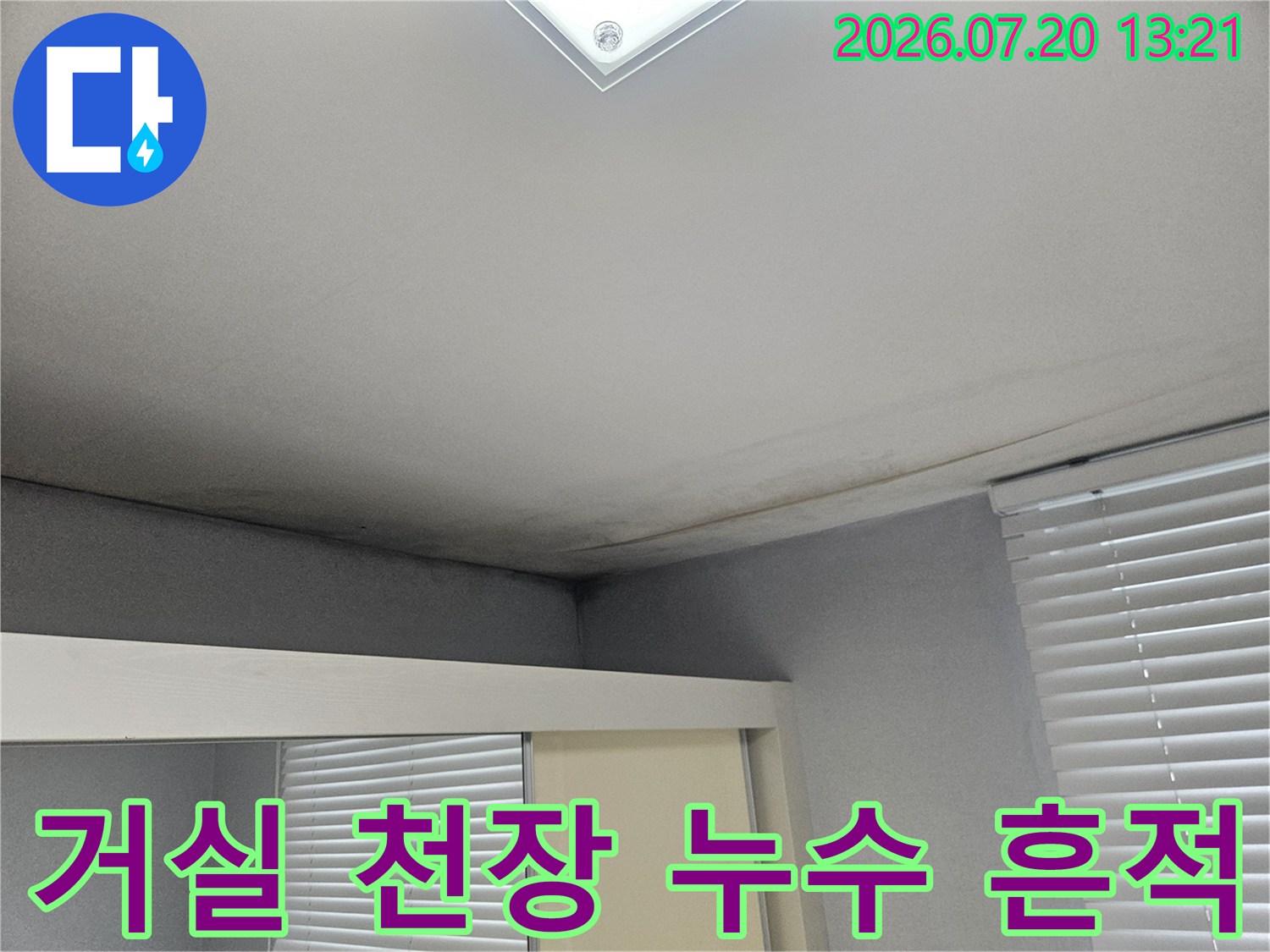 거실 천장 모서리 부분에 발생한 누수 흔적과 변색된 벽면