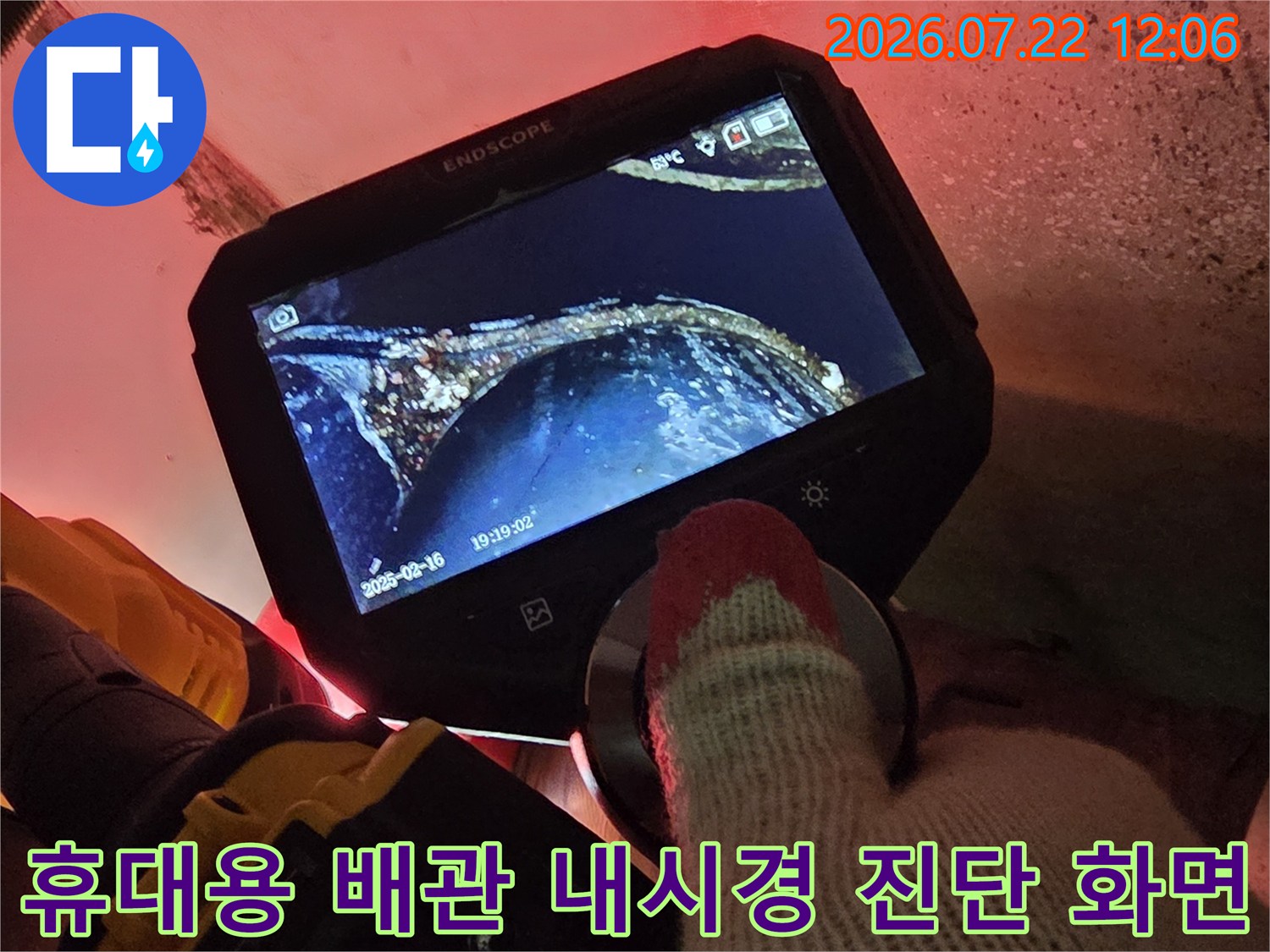 작업자가 들고 있는 내시경 모니터에 비친 배관 내부의 단면과 이물질 모습