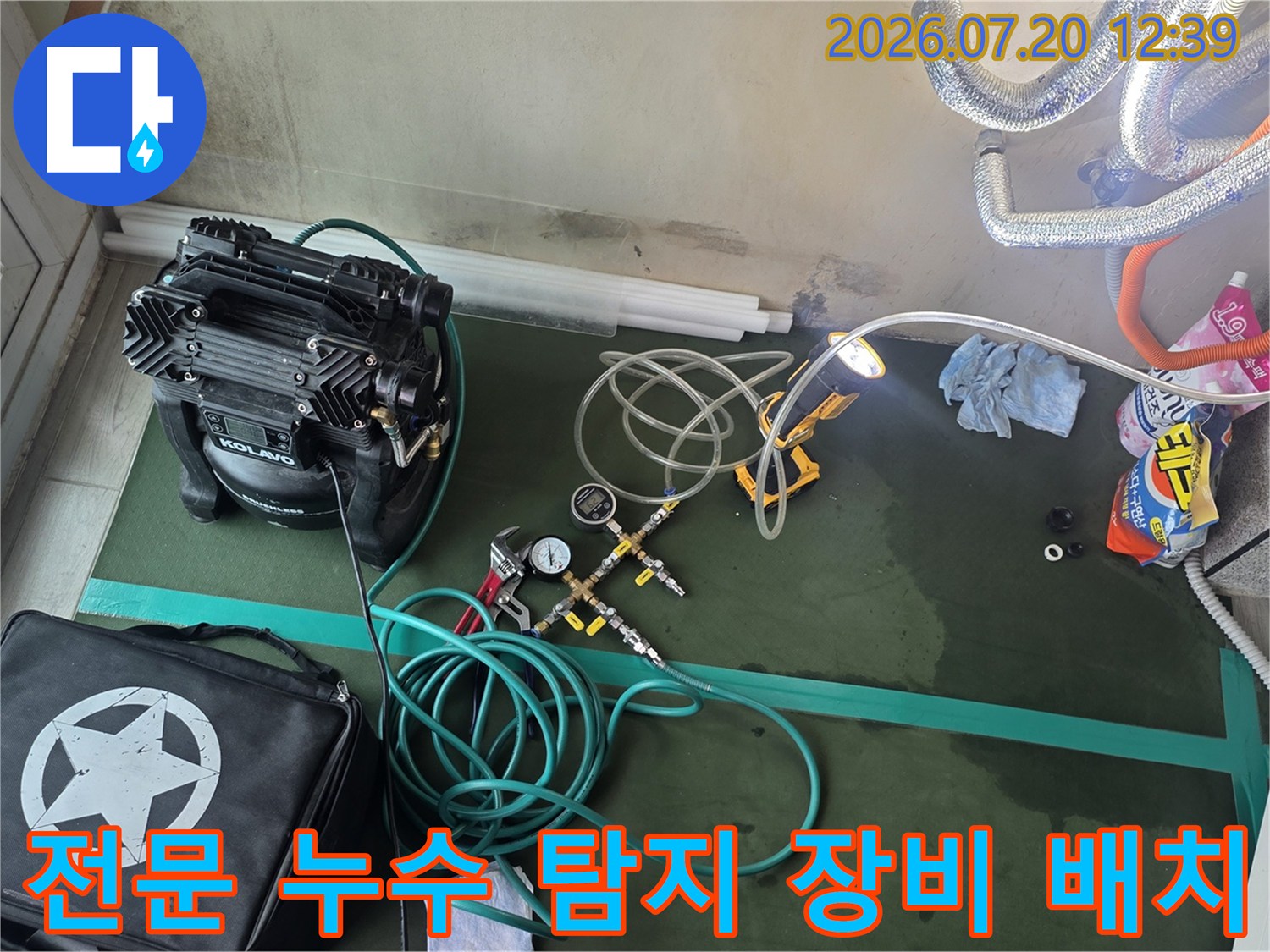 검은색 케이스의 탐지기와 여러 갈래로 뻗은 청색 배관 호스-작업 현장