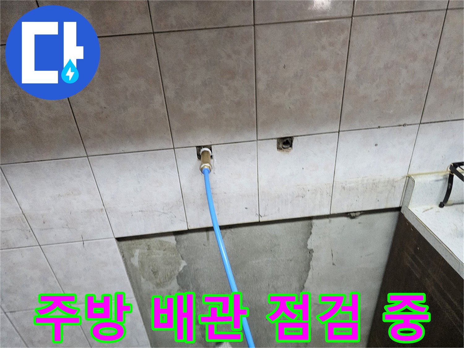 상도동 빌라 주방 타일 사이 노출된 배관 점검 모습