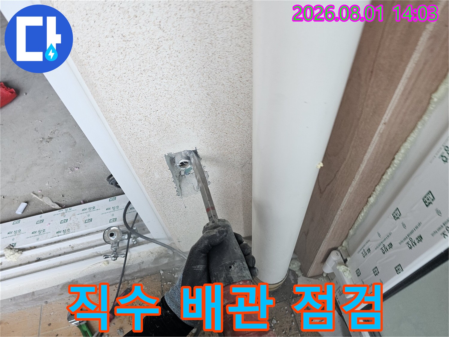 세탁실 벽면의 노출된 직수 배관 연결 부위를 점검하는 모습