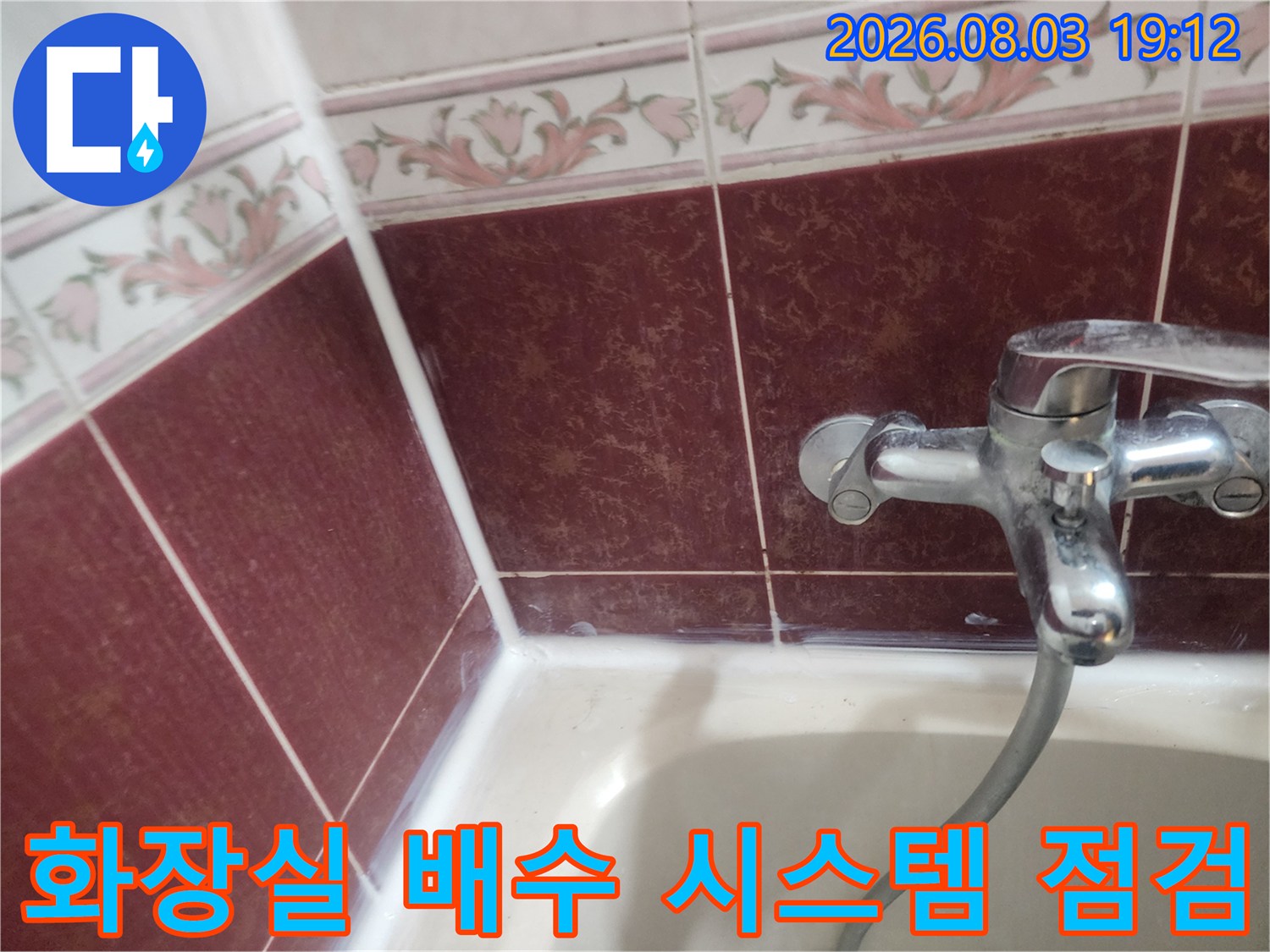 붉은색 계열의 타일이 시공된 욕조 배수 구역 상세 사진