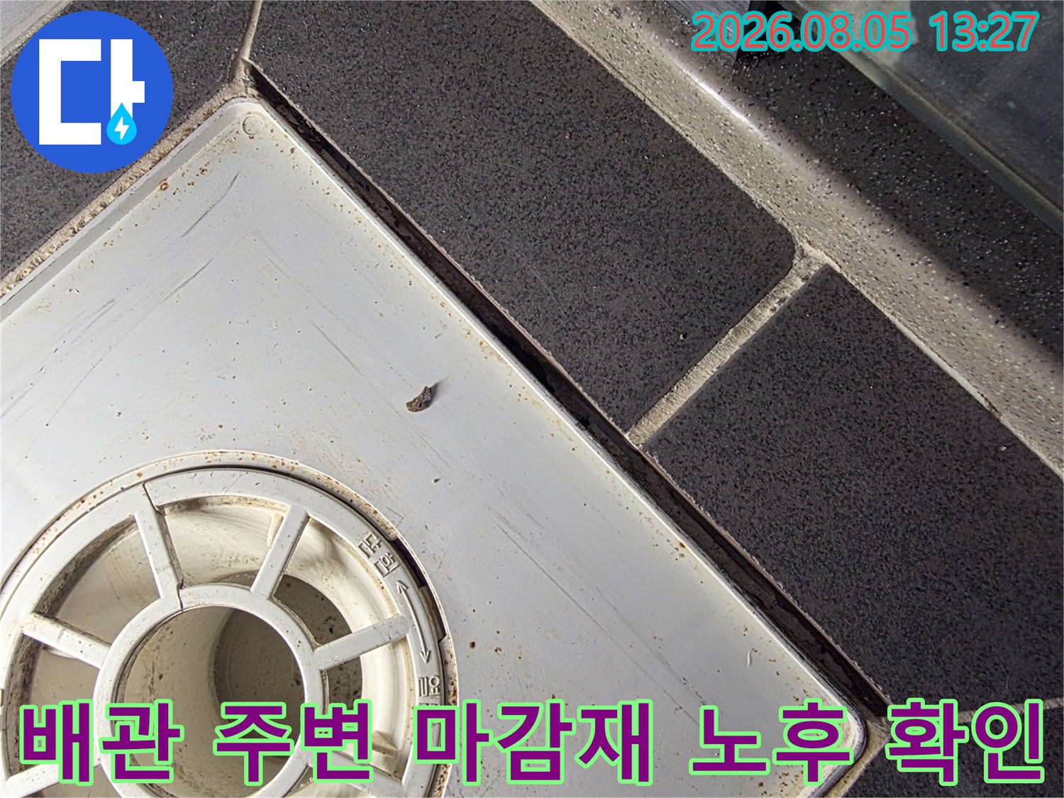 배수 트랩과 주변 타일의 경계면 상태를 세부적으로 촬영한 사진