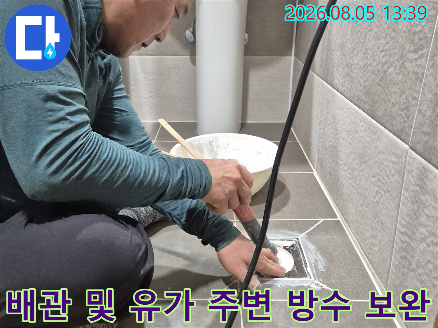 전문 기술자가 배수구 하부 구조를 확인하며 누수 차단 공사를 수행하는 장면