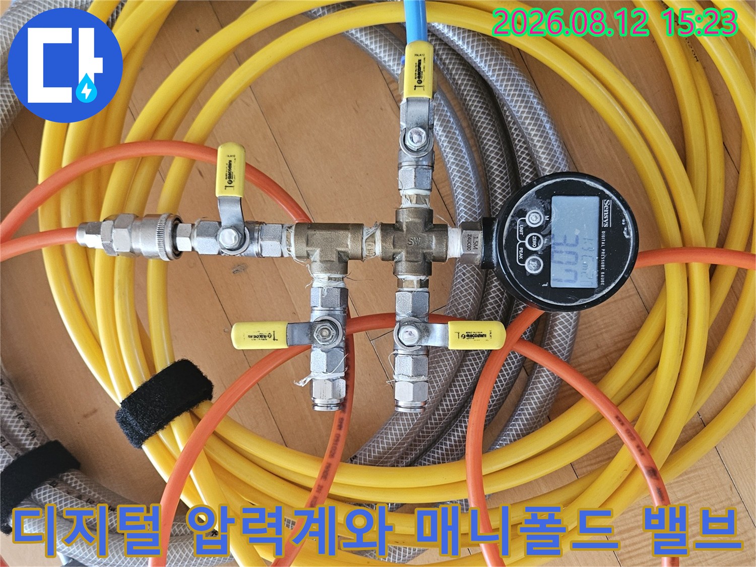 여러 색상의 호스가 연결된 황동제 누수 탐지 밸브 세트와 디지털 측정기-배관 정밀 점검