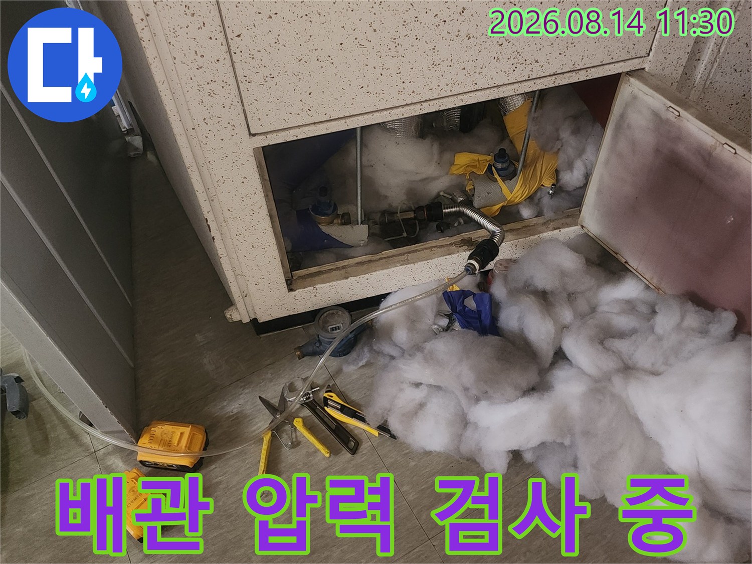 천장 내부 배관의 누수 지점을 찾기 위해 공압 검사 장비를 연결한 현장입니다.