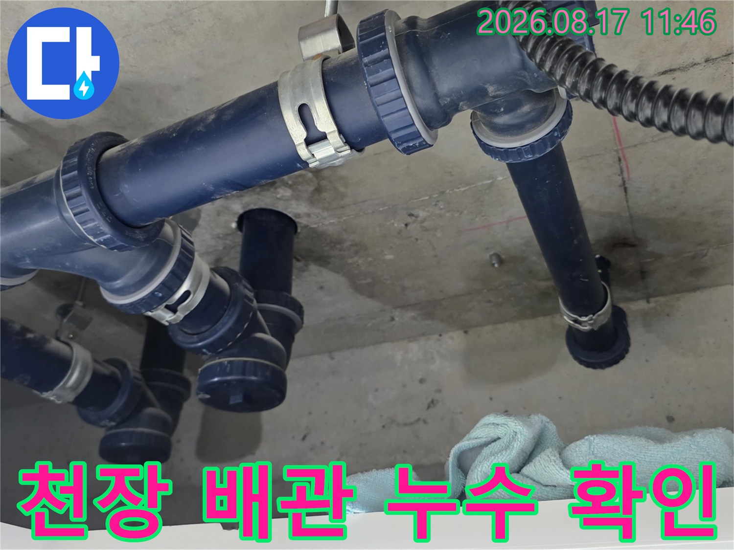 화장실 천장에 설치된 파란색 배수 배관의 연결 부위와 습기 상태입니다.