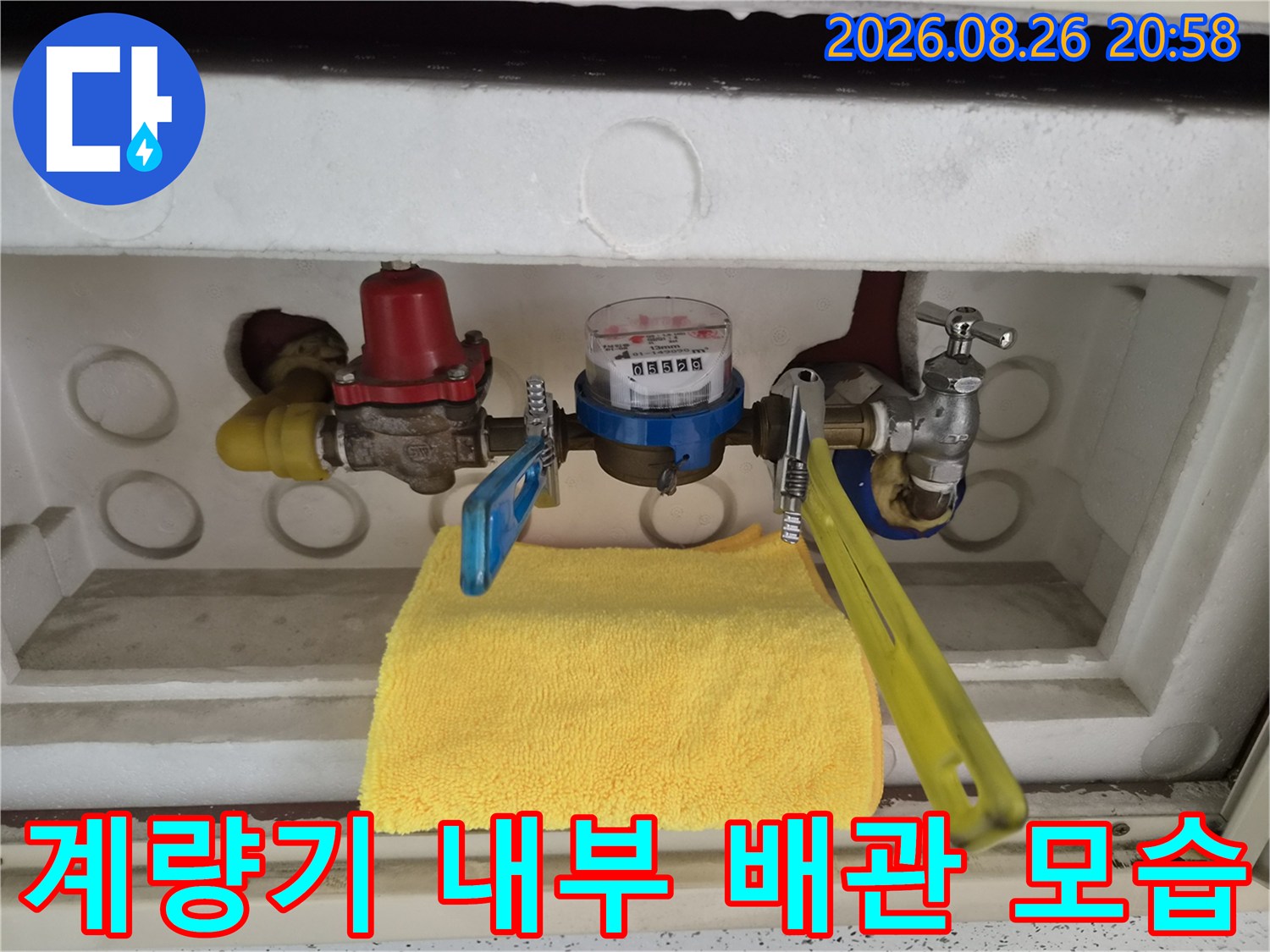 수도 계량기와 파란색 밸브가 설치된 계량기 함 내부 사진입니다.