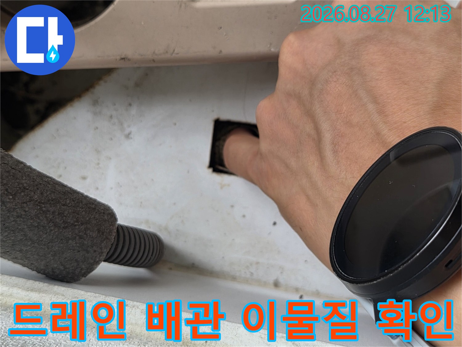 에어컨 배수 라인-배관 내부의 오염 물질을 육안으로 점검 중