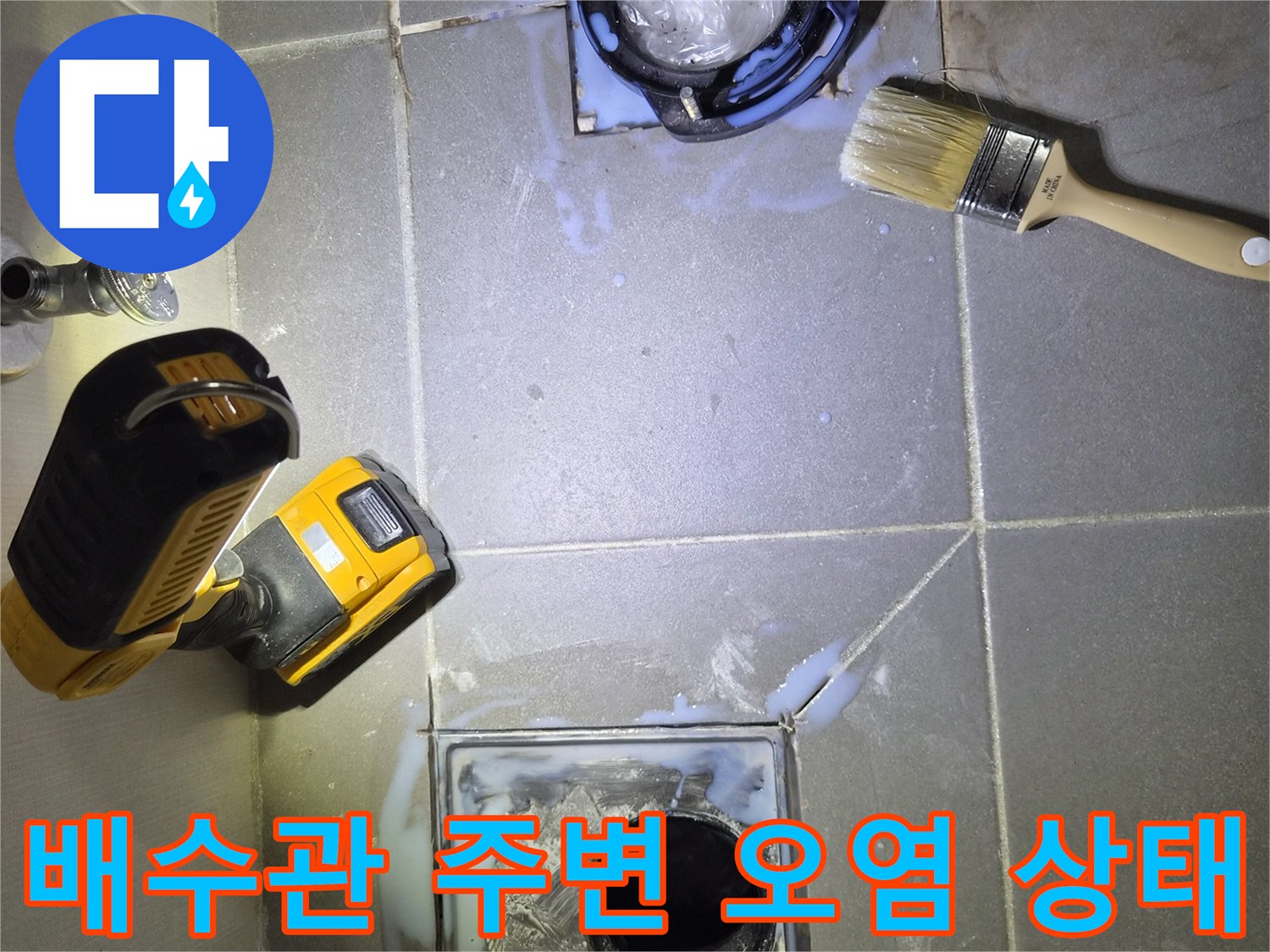 변기 하부 배수구 입구의 습윤한 타일 표면과 브러시