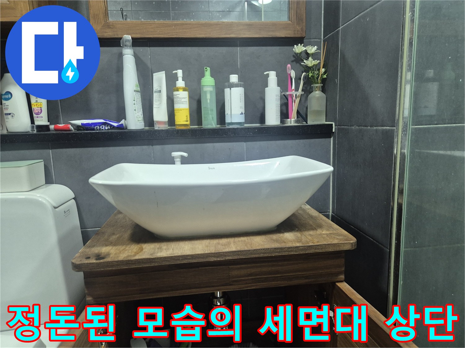 세면대 도기와 주변 용품들이 놓인 욕실 선반 부근