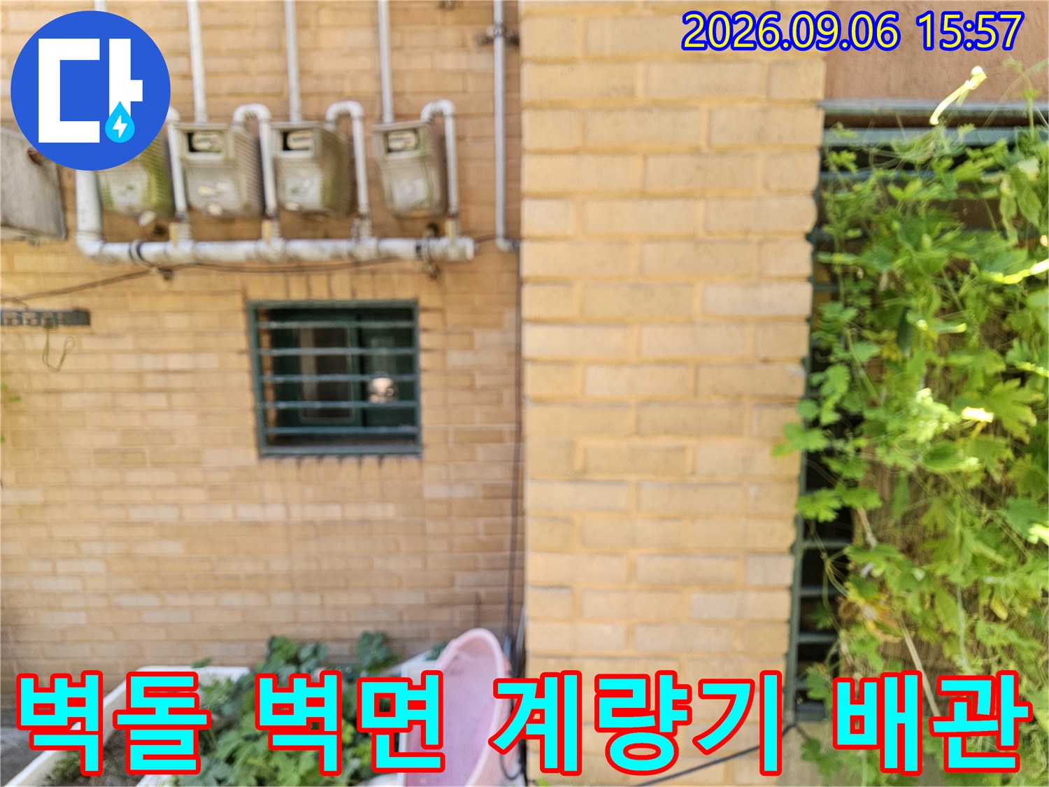 갈현동 빌라 외벽에 설치된 수도 계량기와 노출된 배관 라인