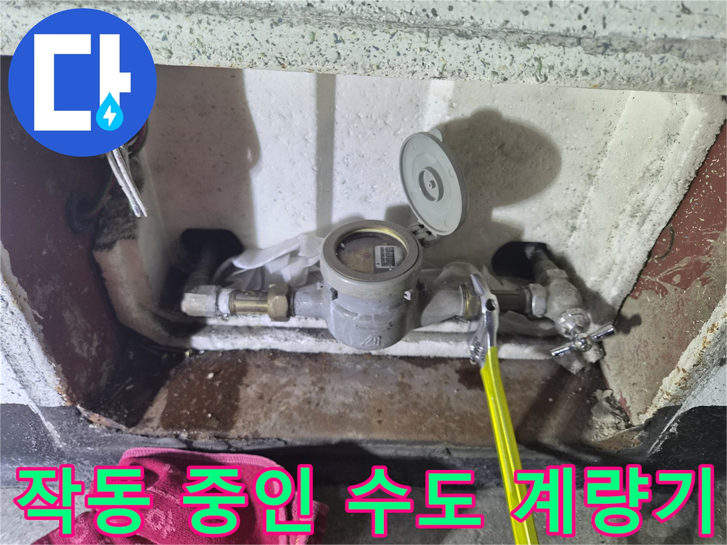 금속 배관 연결 부위와 함께 보이는 수도 계량기의 내부 상태