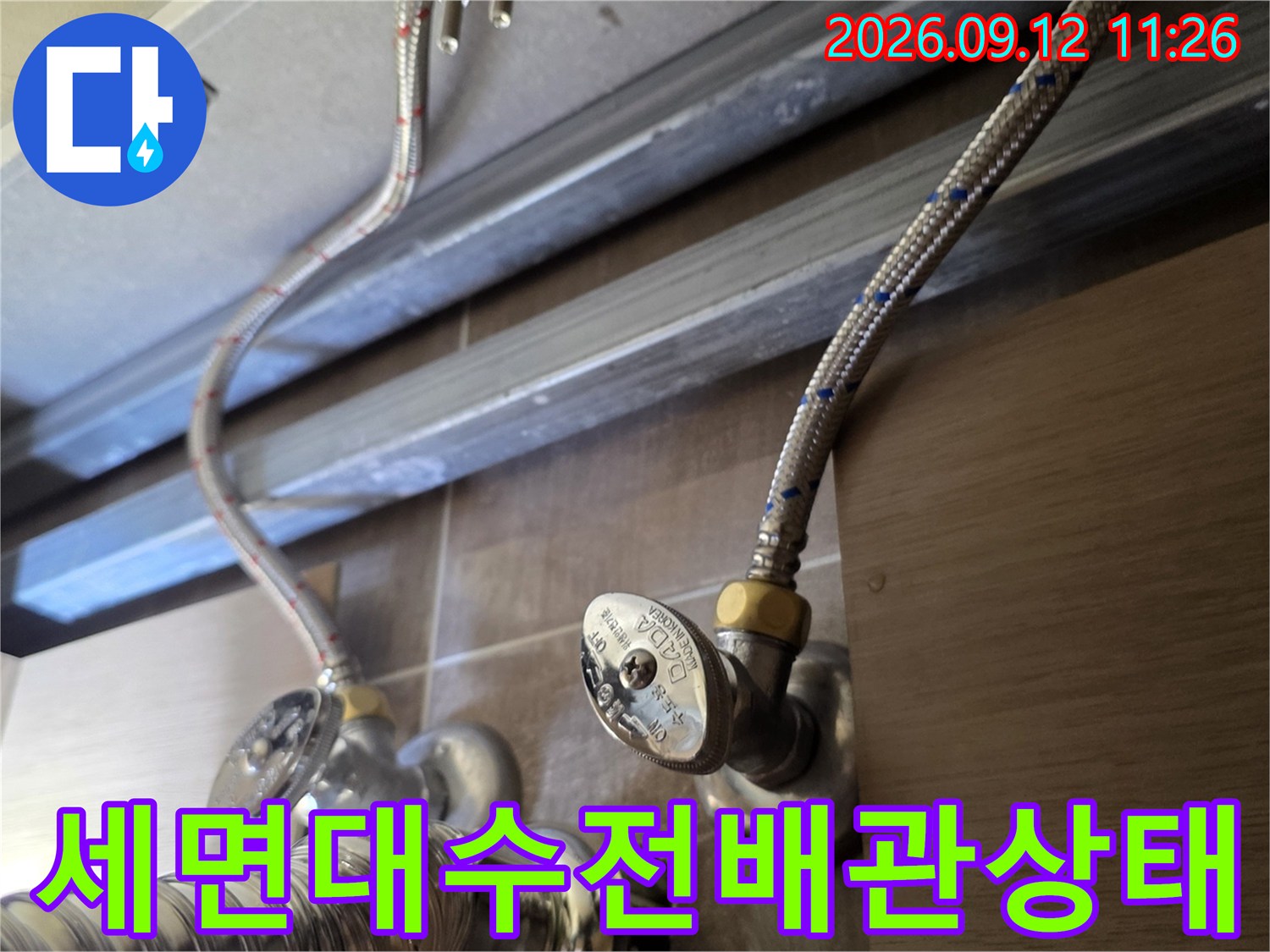세면대-하부장-내부의-금속재질-급수-배관과-수도-밸브-연결-부위